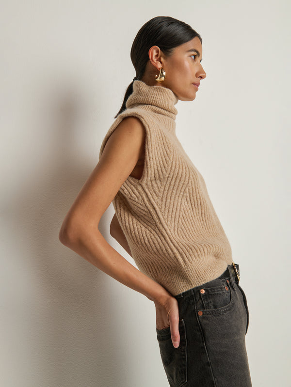 Side view of a model wearing the Nation Los Angeles Isha Turtleneck Tank in Shiny Moonbeam.