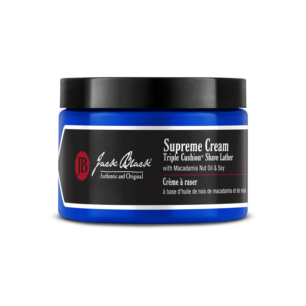 A blue tub of Jack Black Supreme Cream Triple Cushion Shave Lather shaving cream with macadamia nut oil and soy. 