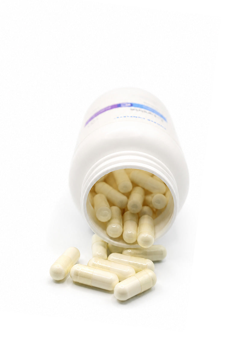 Open white Cooper Complete L-Lysine Supplement pill bottle with capsules spilling out on a white background