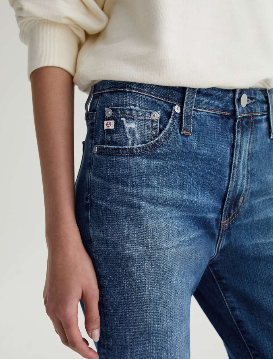 Close up pocket view of model wearing Mari Crop Jean in 15 Years Prague by AG Jeans.