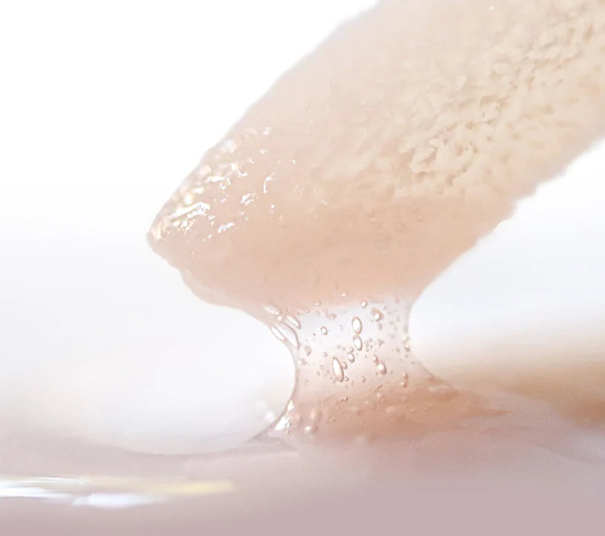 Close up of Ourself Lip Conditioner wand in shade Clear. 