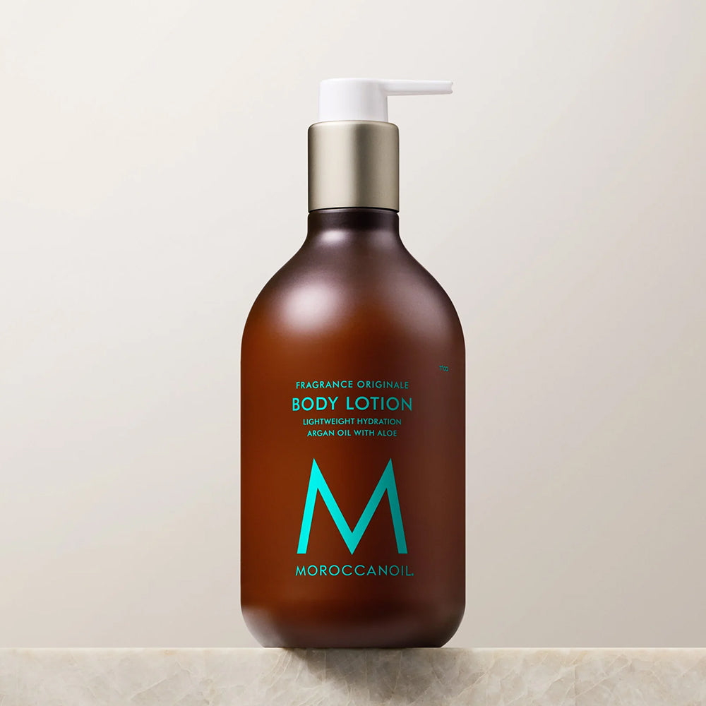 Amber-colored pump bottle of Moroccanoil Fragrance Originale Body Lotion with argan oil and aloe, 12.2 fl oz.