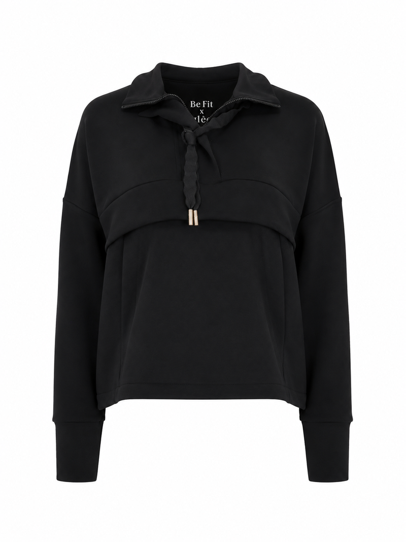 Front view of the Be Fit x Glee black Onyx Raincoat with a high collar, braided drawstrings and layered front panel.