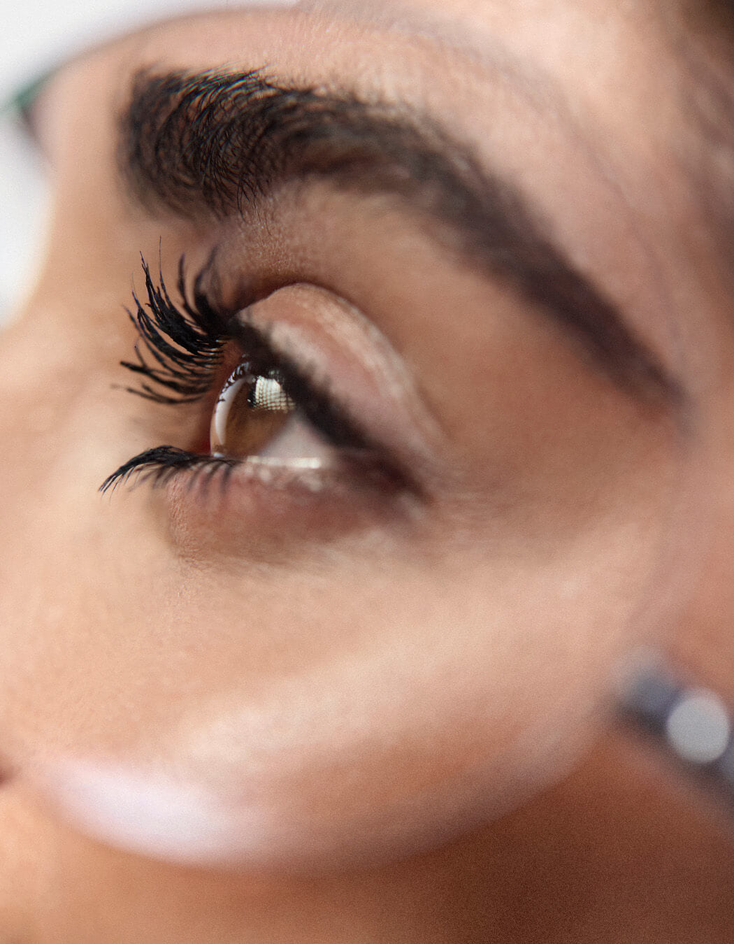 Close up of model's eye wearing RevitaLash Double-Ended Volume Set including volumizing primer and mascara. 