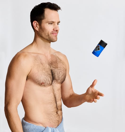 Shirtless male model tossing a Jack Black Original Pit Boss Antiperspirant & Deodorant stick.