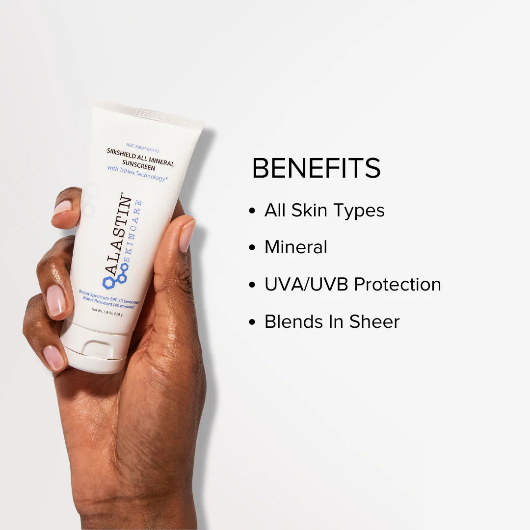 Hand holding bottle of Alastin SilkSHIELD All Mineral SPF 30 against a white background for all skin types with UVA/UVB protection and sheer blending. 