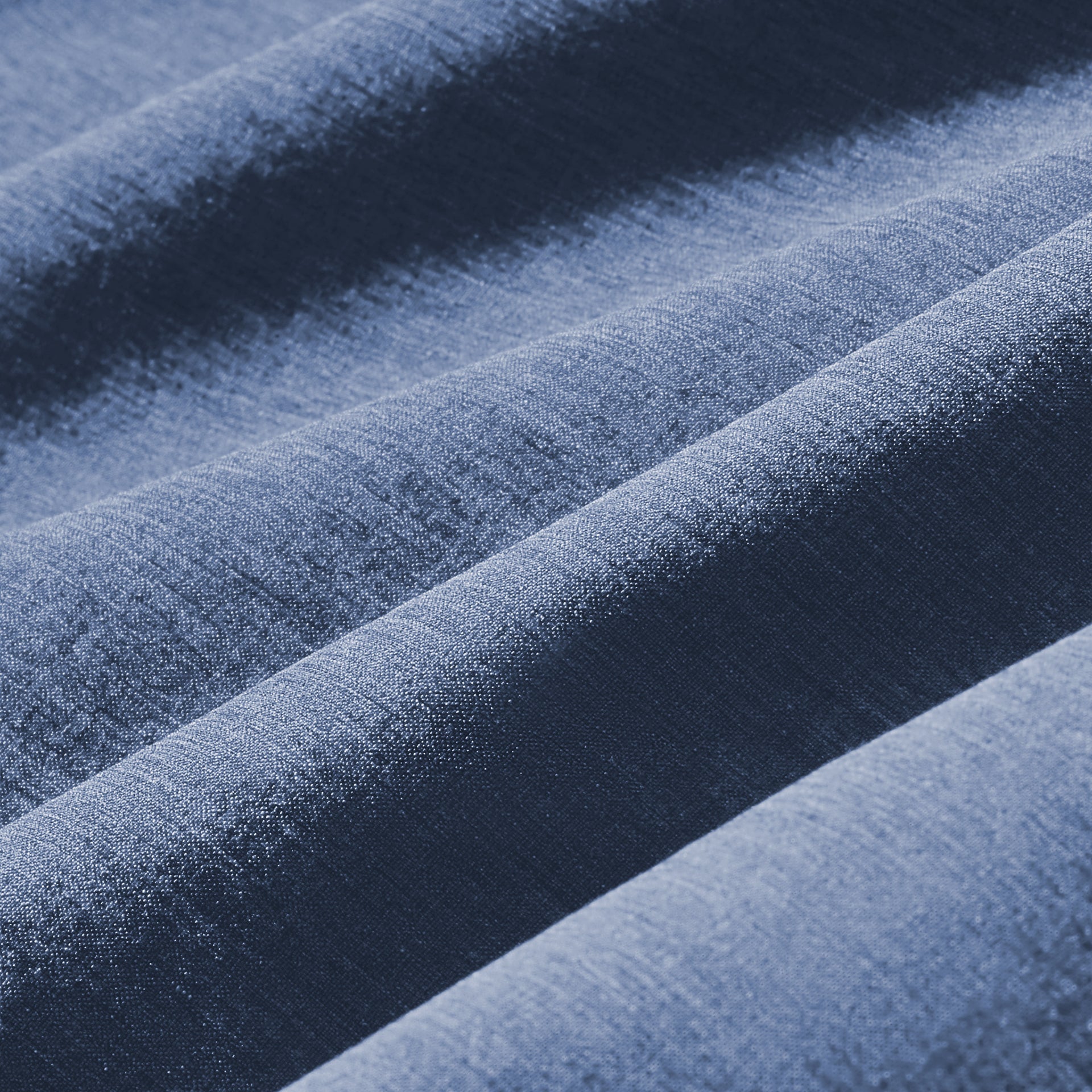 Fabric swatch of the Mizzen+Main Leeward Short Sleeve Dress Shirt in Coastal Fjord Heather (chambray blue), showing the lightweight four-way stretch performance fabric and heathered texture.