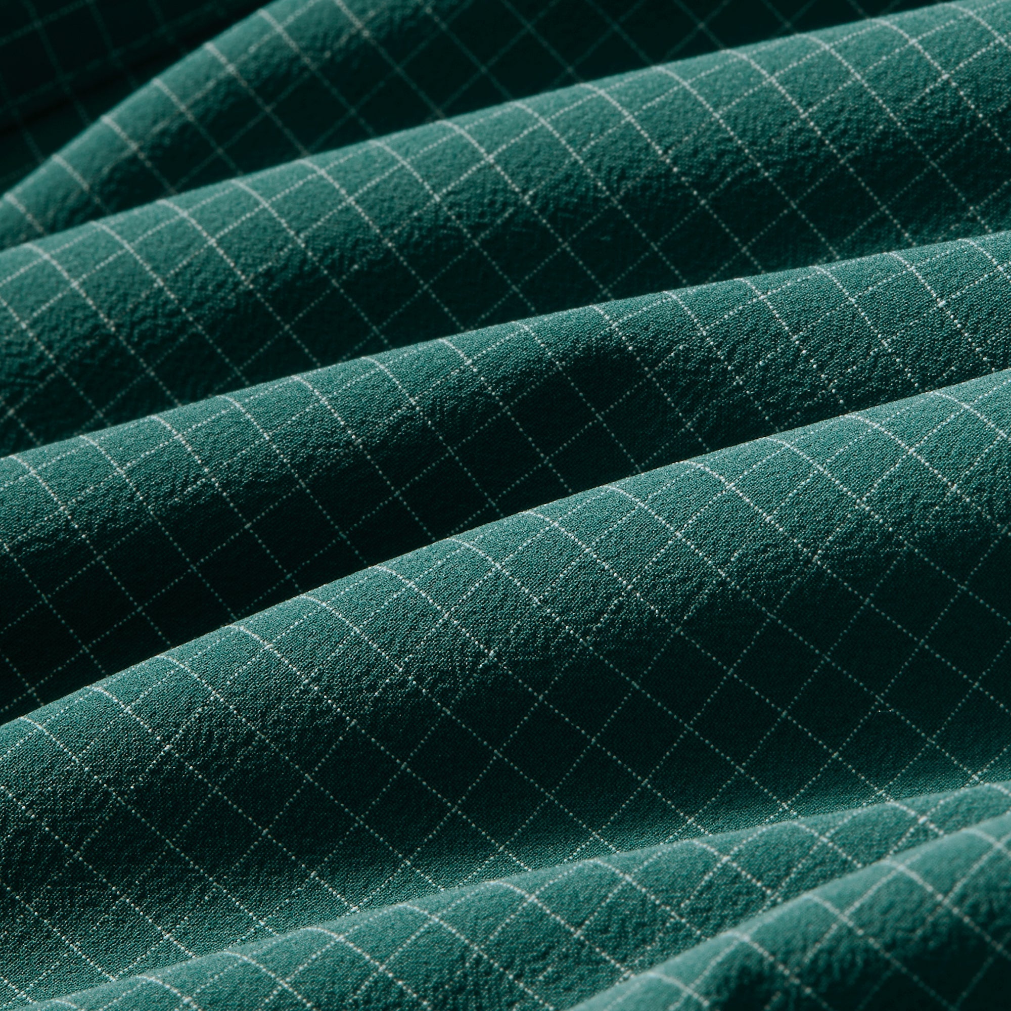 Fabric swatch of the Mizzen+Main Leeward Long Sleeve Dress Shirt in Dark Sea Noah Tattersall (deep teal and white check), showing the lightweight four-way stretch performance fabric and check pattern.