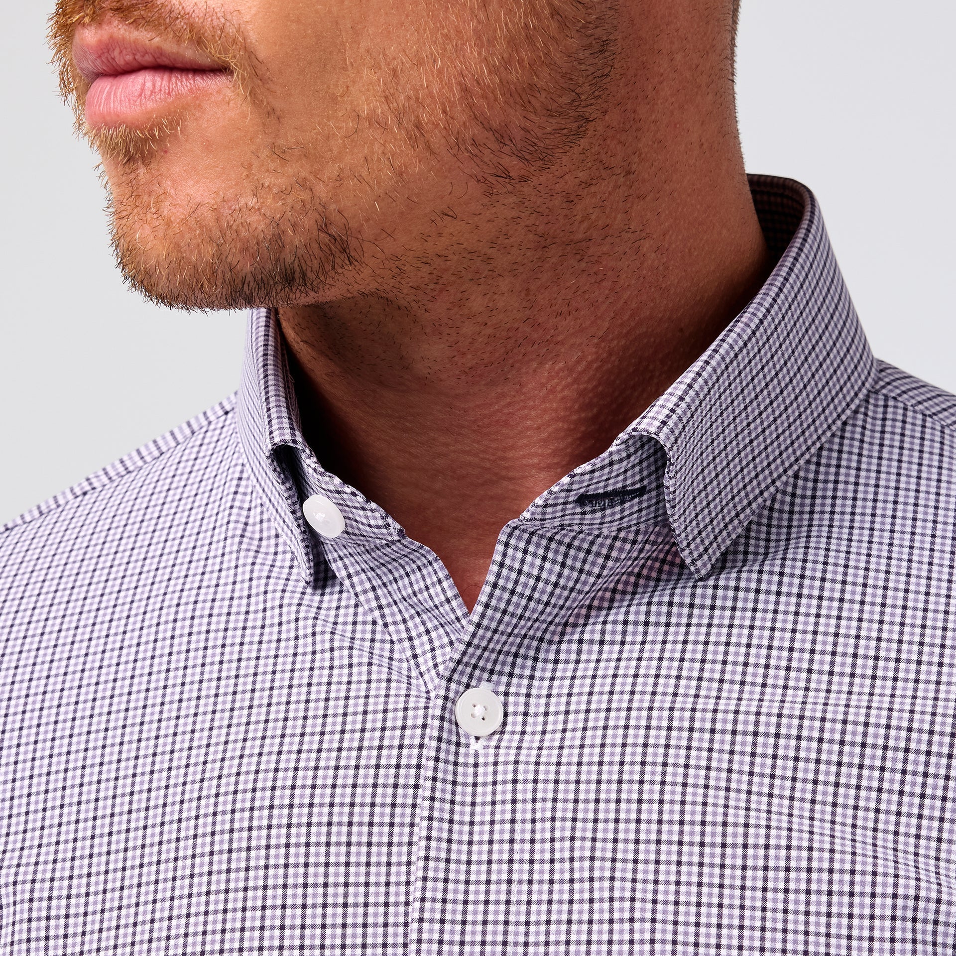 Close-up of the spread collar and neckline on the Mizzen+Main Leeward Long Sleeve Dress Shirt in Purple Dusk Sam Plaid (soft lavender and navy plaid).