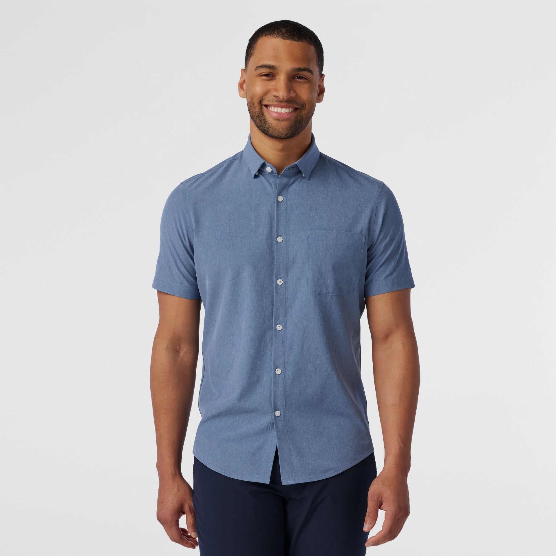 Front view of the Mizzen+Main Leeward Short Sleeve Dress Shirt (Trim Fit) in Coastal Fjord Heather (chambray blue), highlighting the heathered fabric and spread collar.