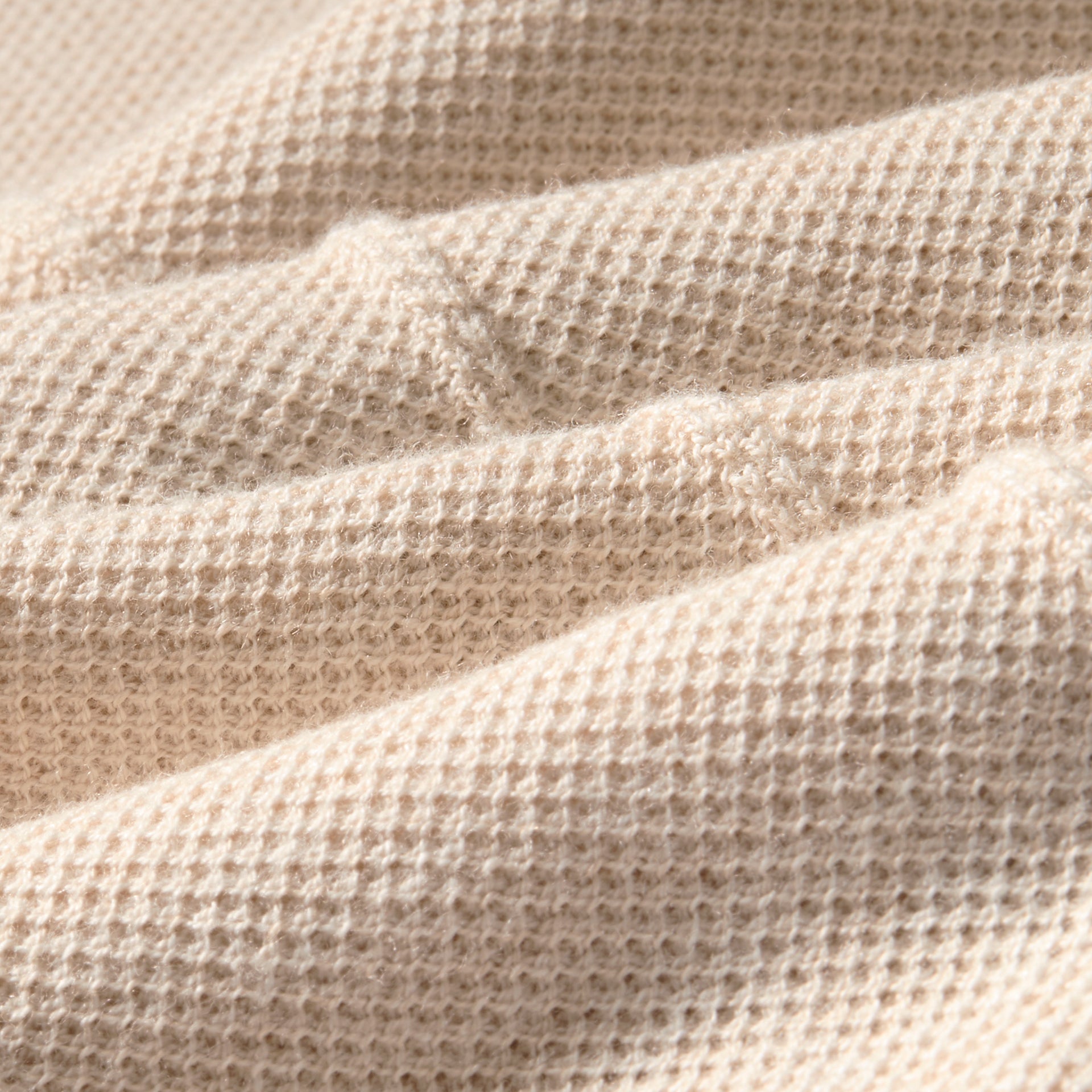 Close up of the beige fabric in the breathable COOLMAX® fabric Mizzen+Main Ashe Short Sleeve Polo Sweater .