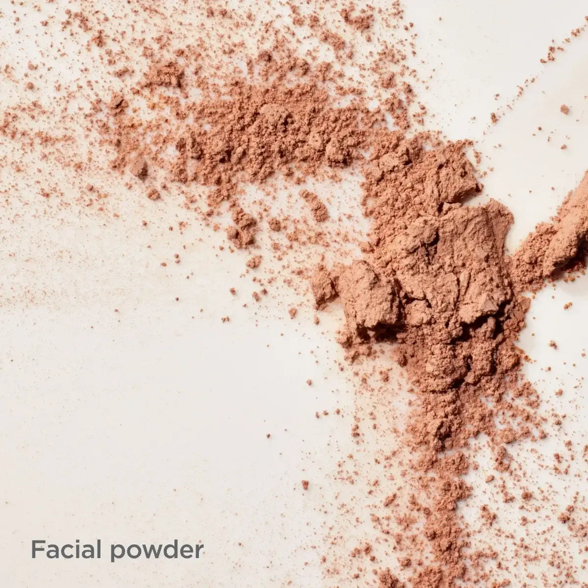 ISDIN Mineral Brush photoaging defense facial powder scattered against a light neutral background. 