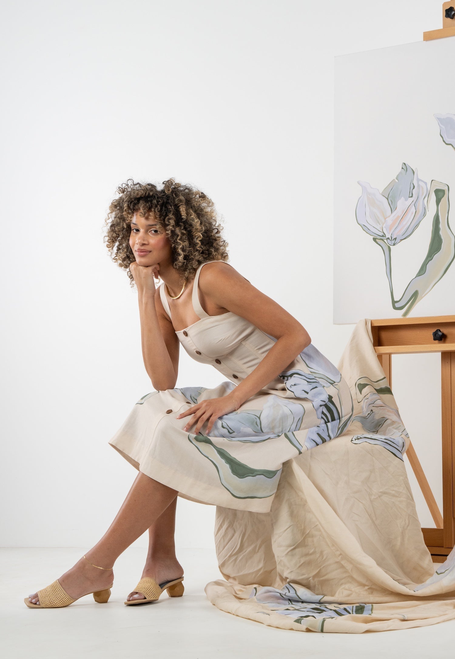 Side view of a model wearing the Emily McCarthy Constance Midi Dress in the Lavender Fields print.