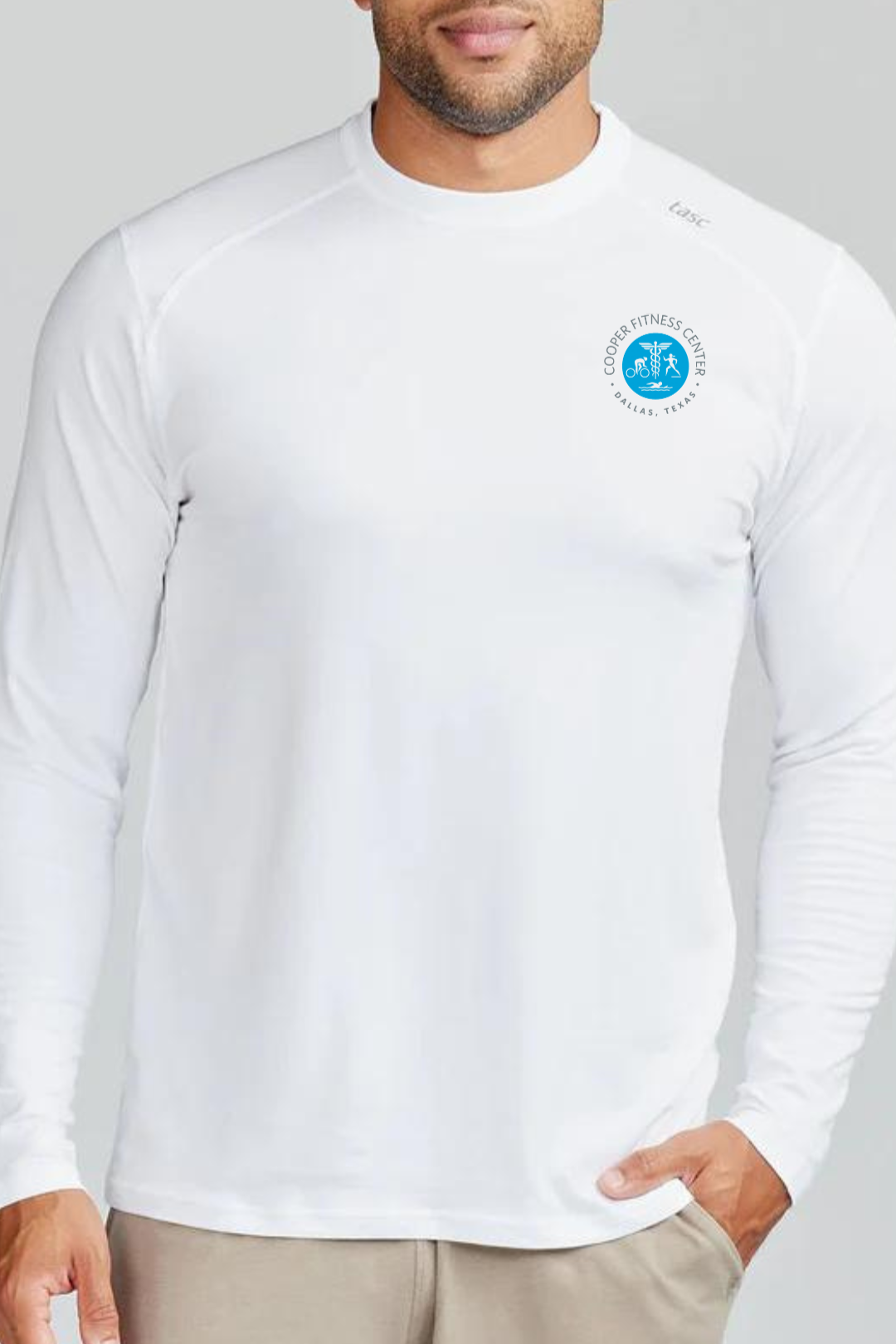 Front view of the Tasc Carrollton Fitness Long Sleeve T-Shirt in White, highlighting the embroidered Cooper Fitness Center logo and classic crew neckline.