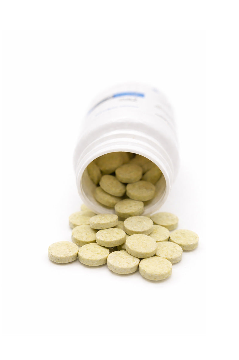Open white Cooper Complete Zinc Complex Supplement pill bottle with pills spilling out on a white background
