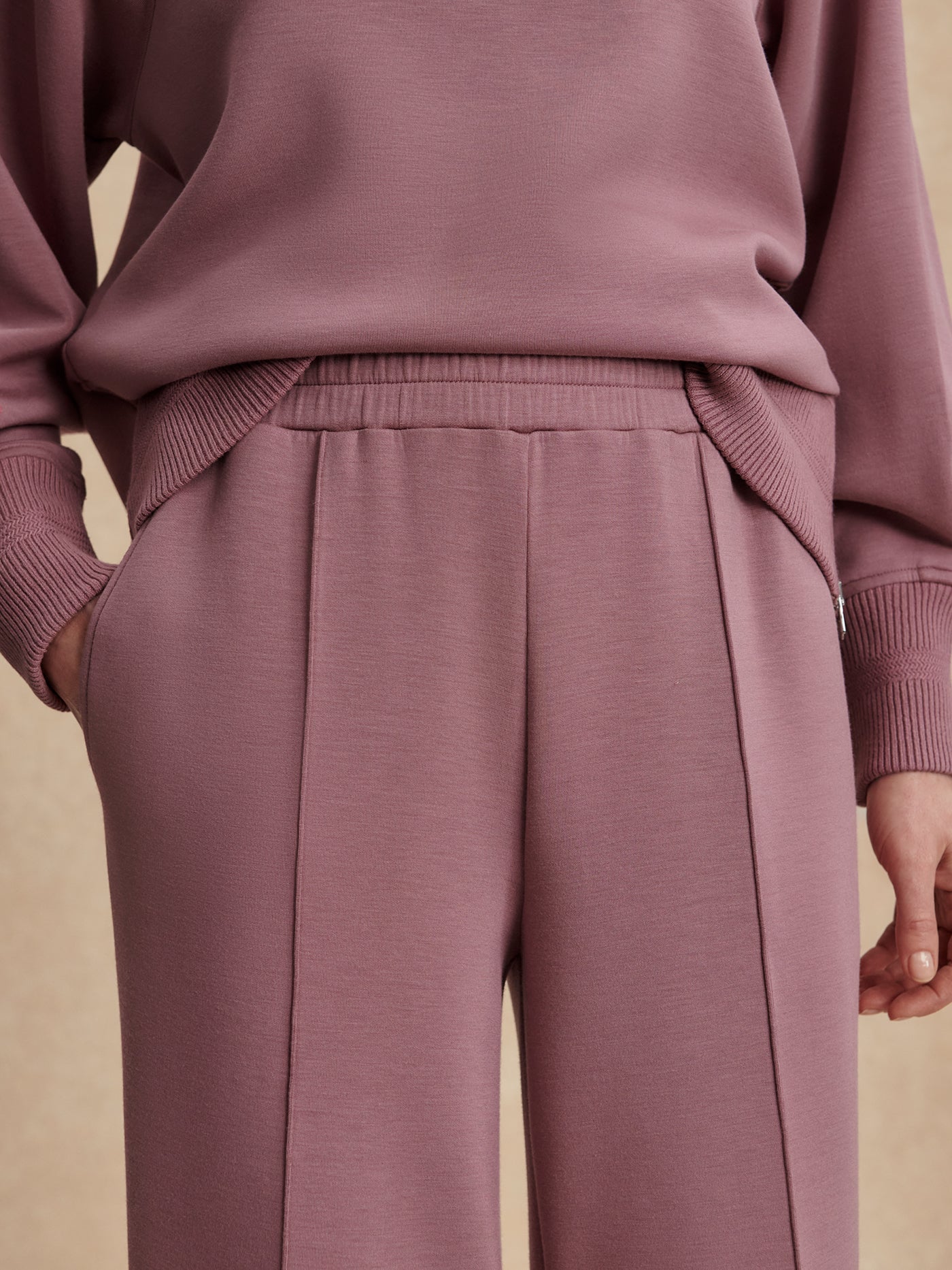 Close-up of the Varley The Wide Leg Pant 30" in Wistful Mauve, highlighting the elastic waistband with internal drawcord.