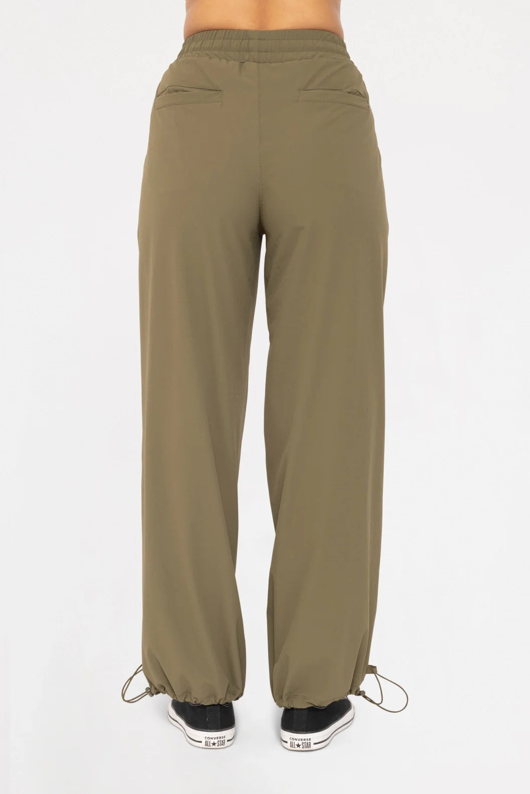 Back view of a model wearing the Be Fit Convertible Cargo Pant in green.