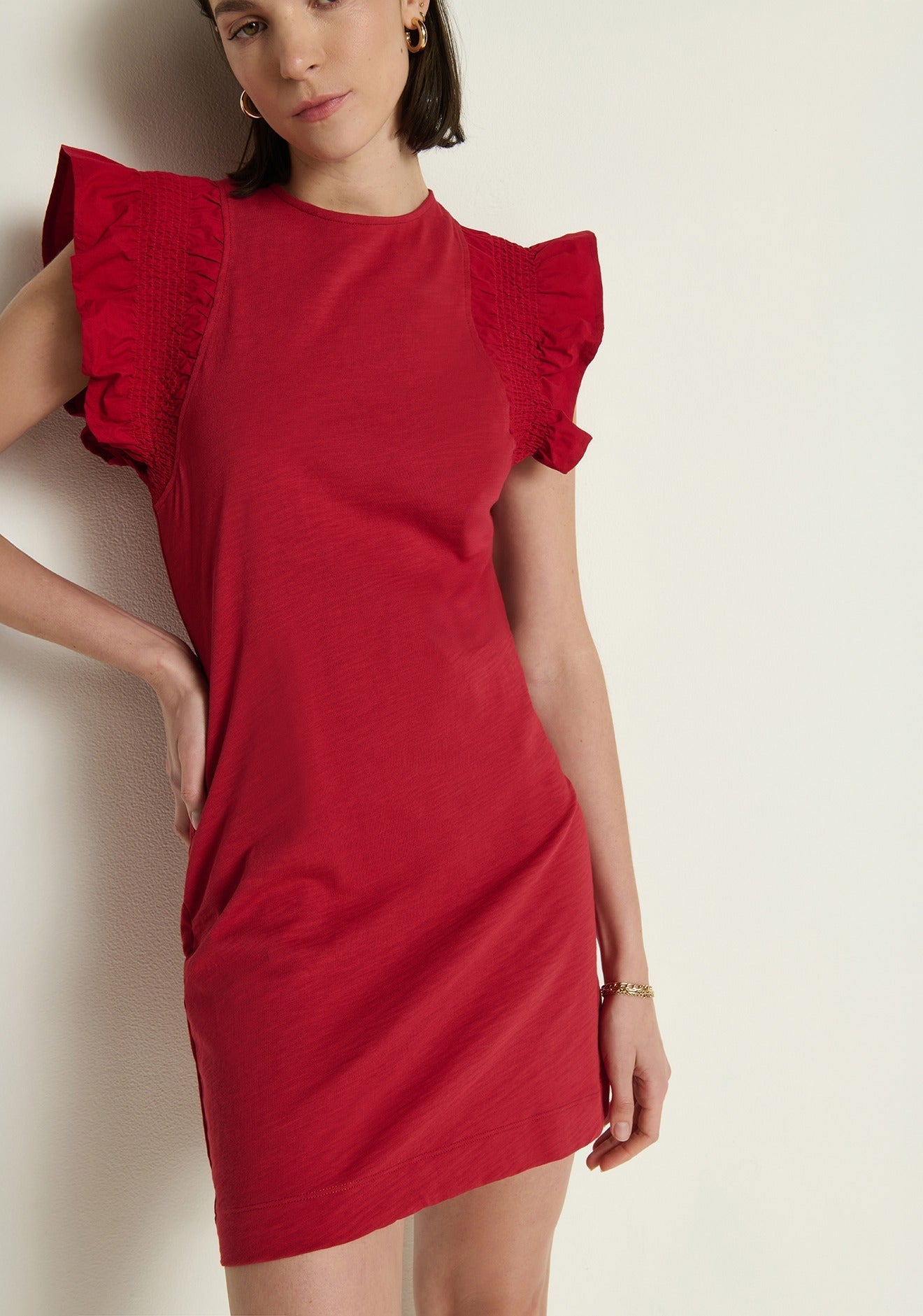 Model wearing the Nation Los Angeles Ellis Ruffle Sleeve Dress in Rio Red, front view.
