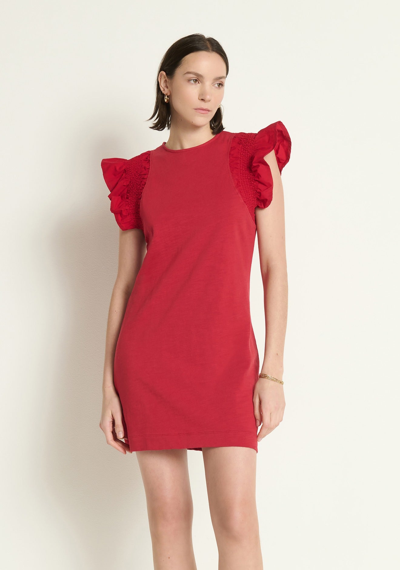 Model wearing the Nation Los Angeles Ellis Ruffle Sleeve Dress in Rio Red, front view.