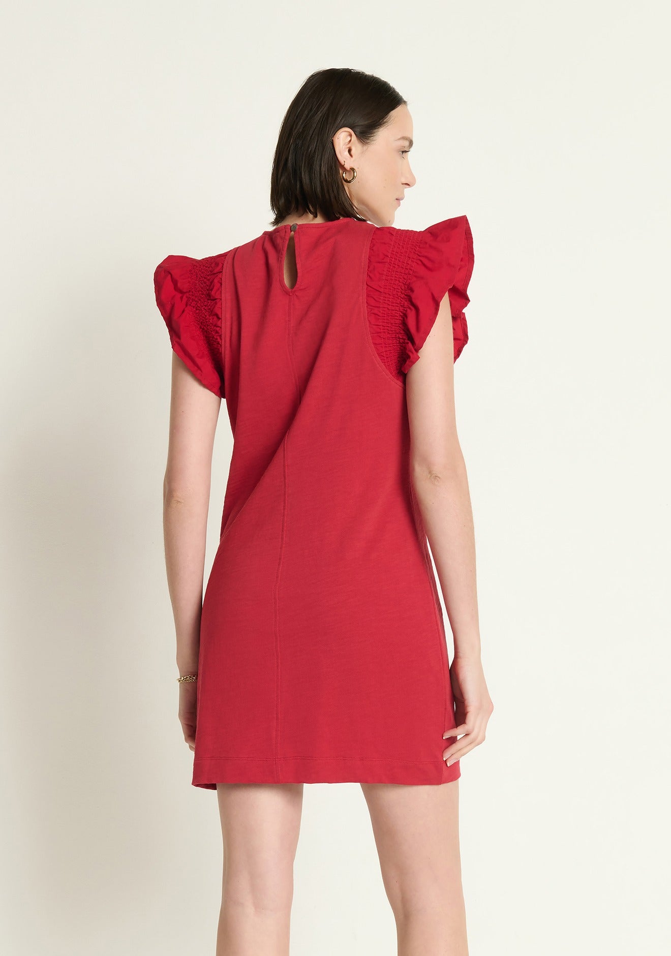 Back view of a model wearing the Nation Los Angeles Ellis Ruffle Sleeve Dress in Rio Red.