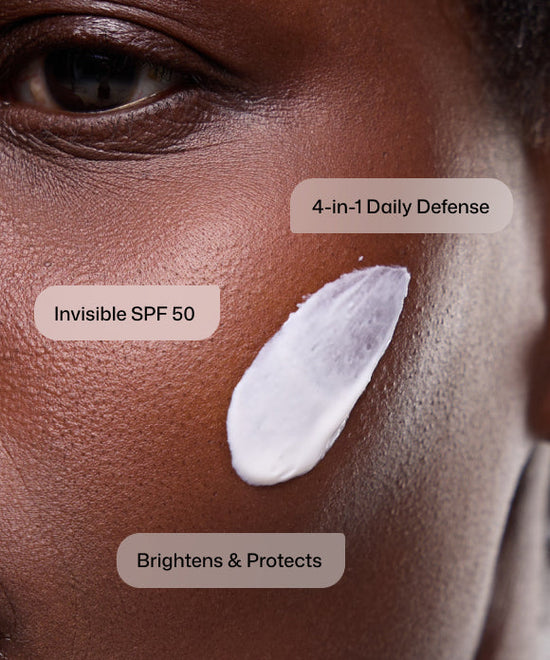 Close up of woman applying Revision Skincare Intellishade Clear invisible SPF 50 as a 4-in-1 daily defense to brighten and protect skin. 