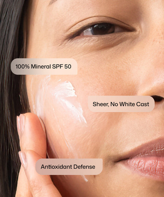 Close up of woman applying Revision Skincare Intellishade TruPhysical Clear 100% Mineral SPF 50 with no white cast for antioxidant defense. 