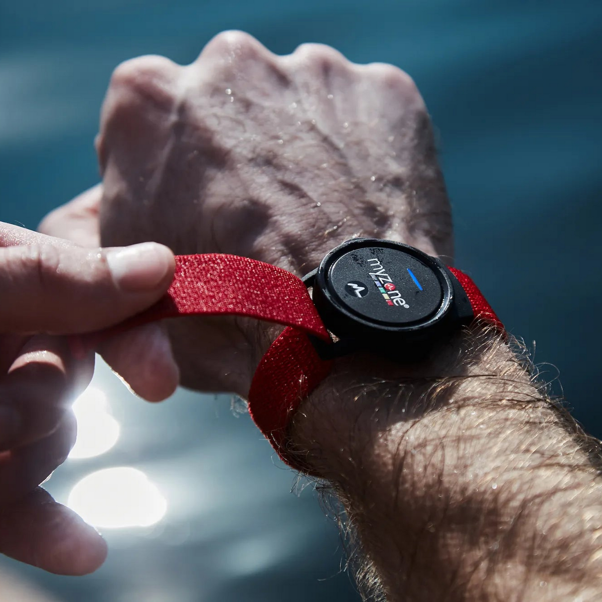 Close-up of the MYZONE MZ-Switch heart rate monitor on wrist.