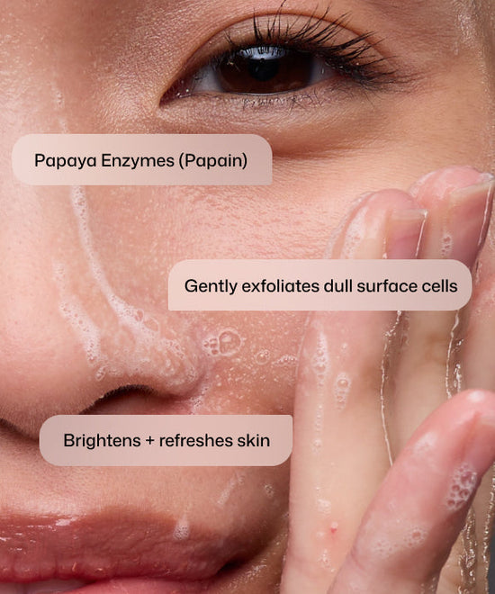 Close up of woman using Revision Skincare Papaya Enzyme Cleanser with papaya enzymes (papain) to gently exfoliate dull surface cells and brighten and refresh skin. 