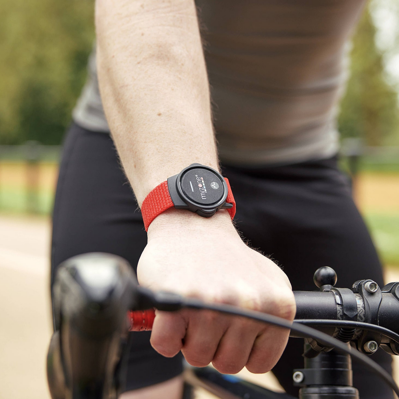 Close-up of the MYZONE MZ-Switch heart rate monitor on wrist of cyclist.